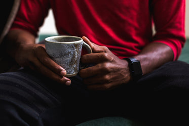 close up man holding coffee cup