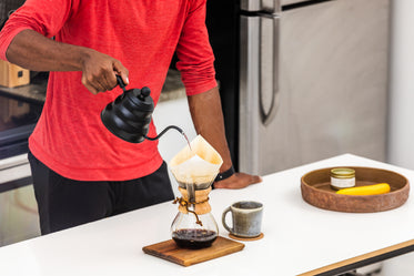 close up man making pour over coffee