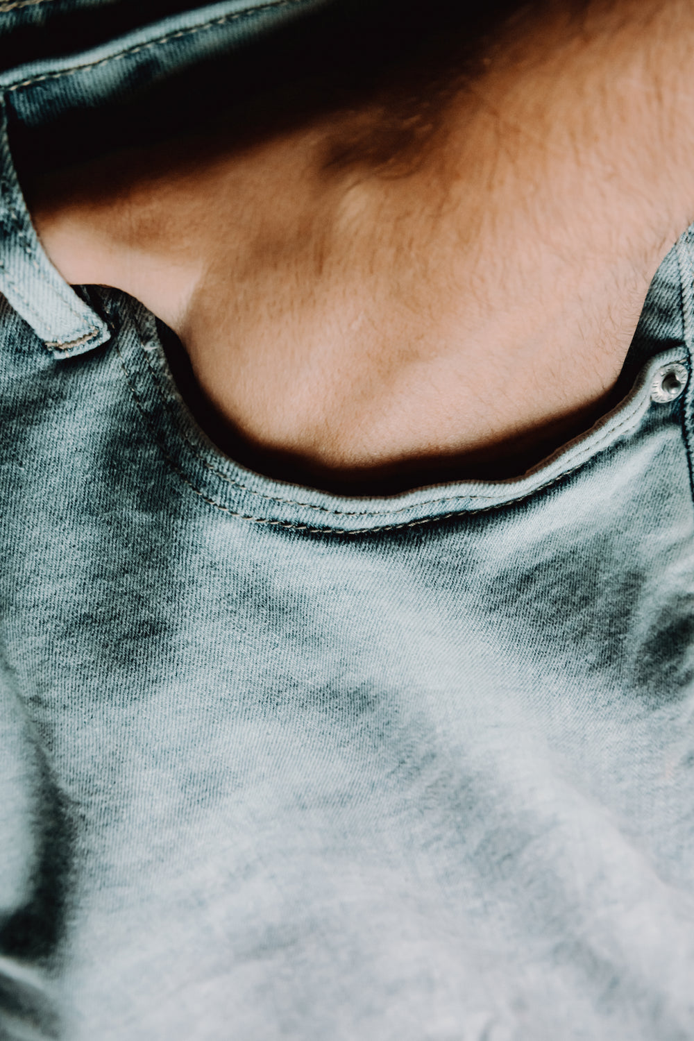 close up of a hand in a blue jean pocket