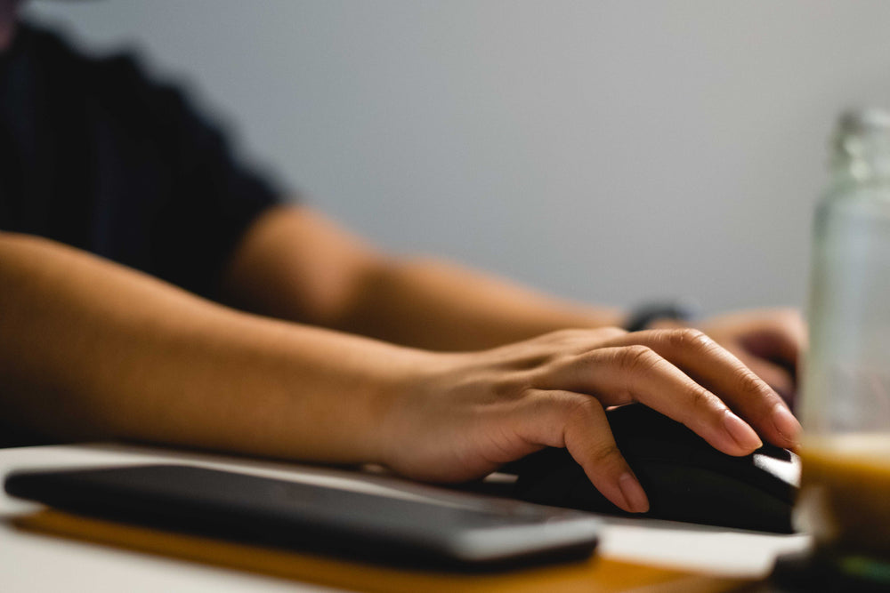 close up of a hand using a computer mouse