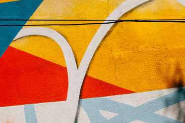 close up of a painted cement wall with splashes of colour