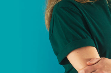 close up of a persons shoulder wearing a green shirt