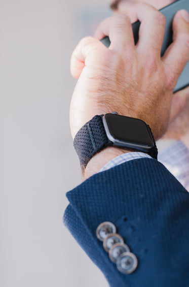 close up of a persons wrist with a watch on it