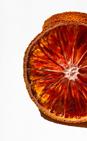 close up of a slice of orange against white