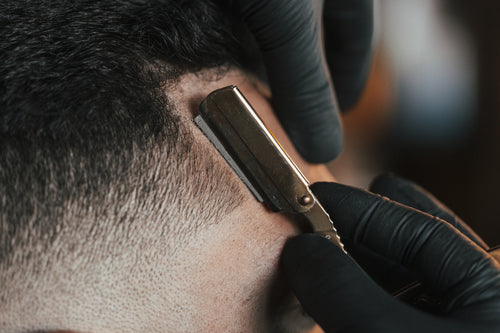 close up of a straight razor in use