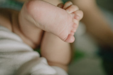 close up of a toddler holding their foot
