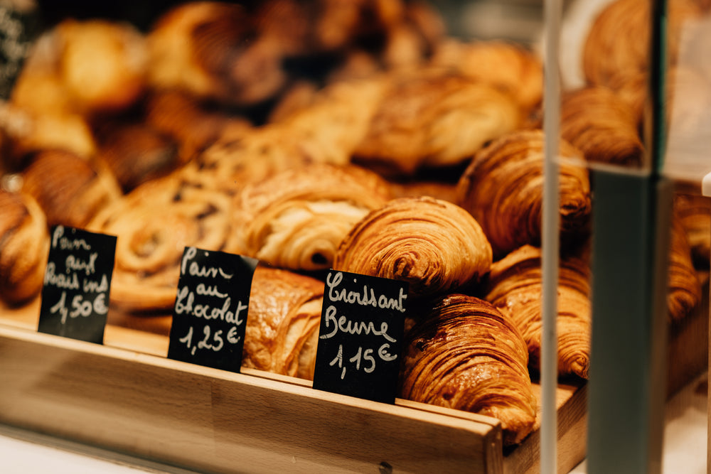 close up of a tray of croissants in a shop window