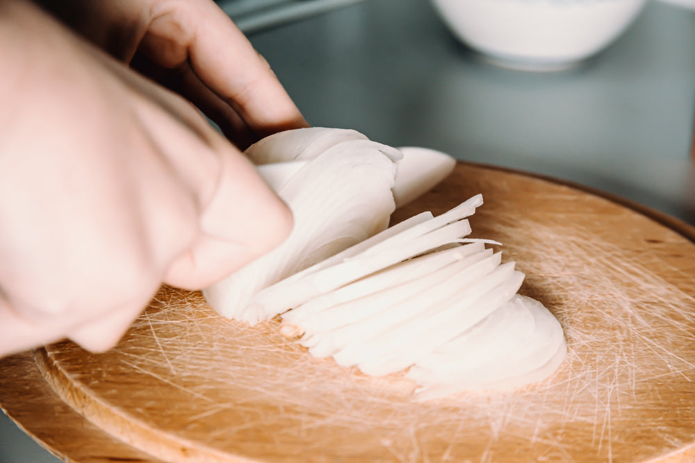 close up of a white onion being chopped