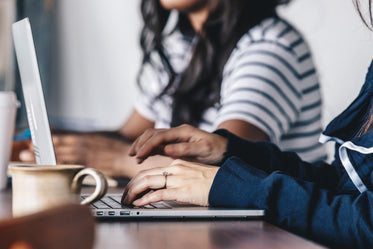 close up of a woman's hands while typing