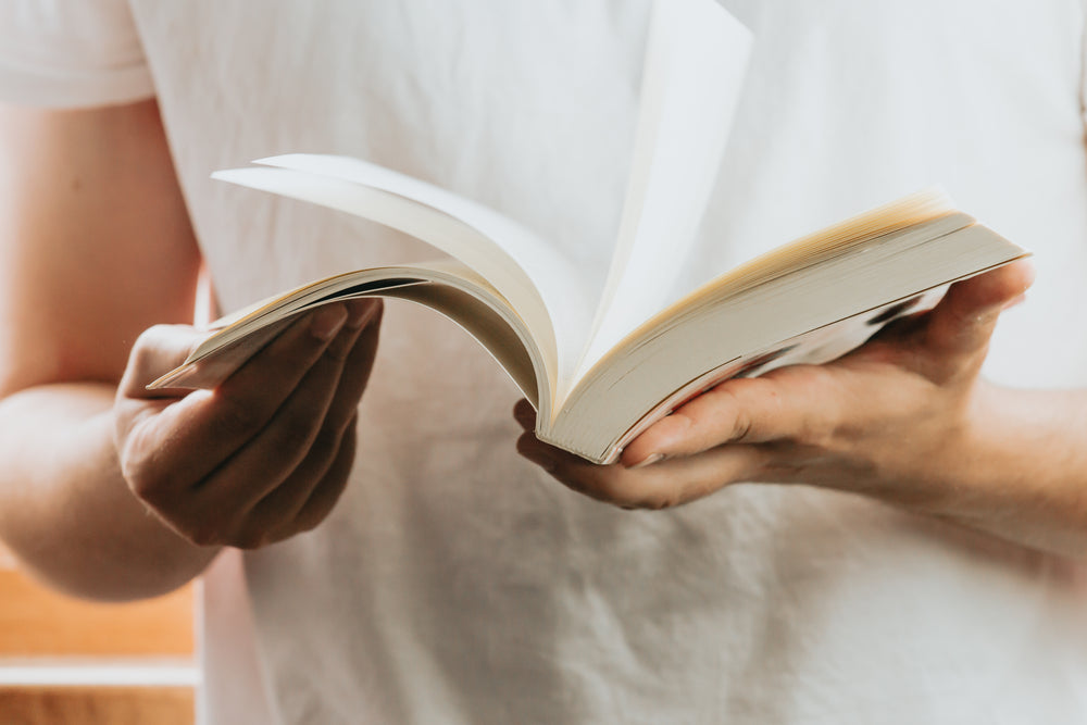 close up of an open novel in a persons hand