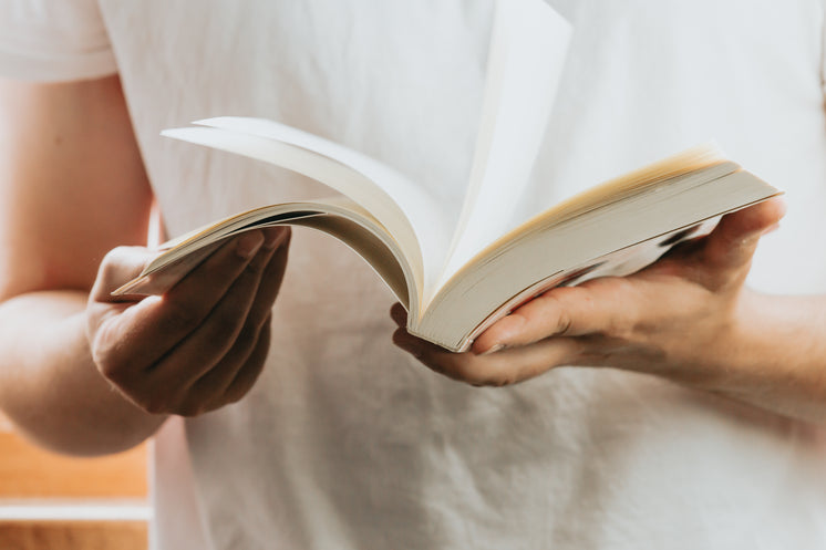 Close Up Of An Open Novel In A Persons Hand