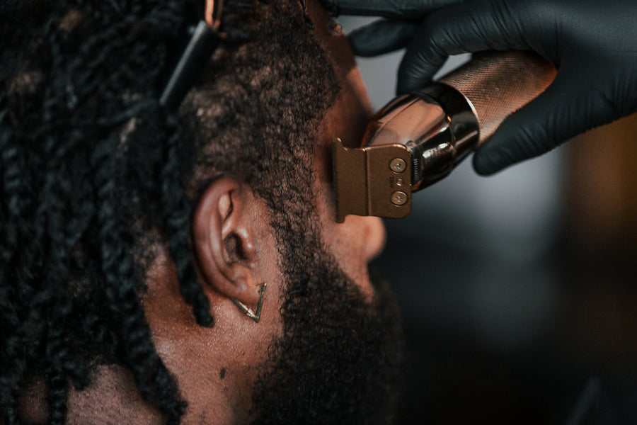 Close up of barber cutting hair with clippers