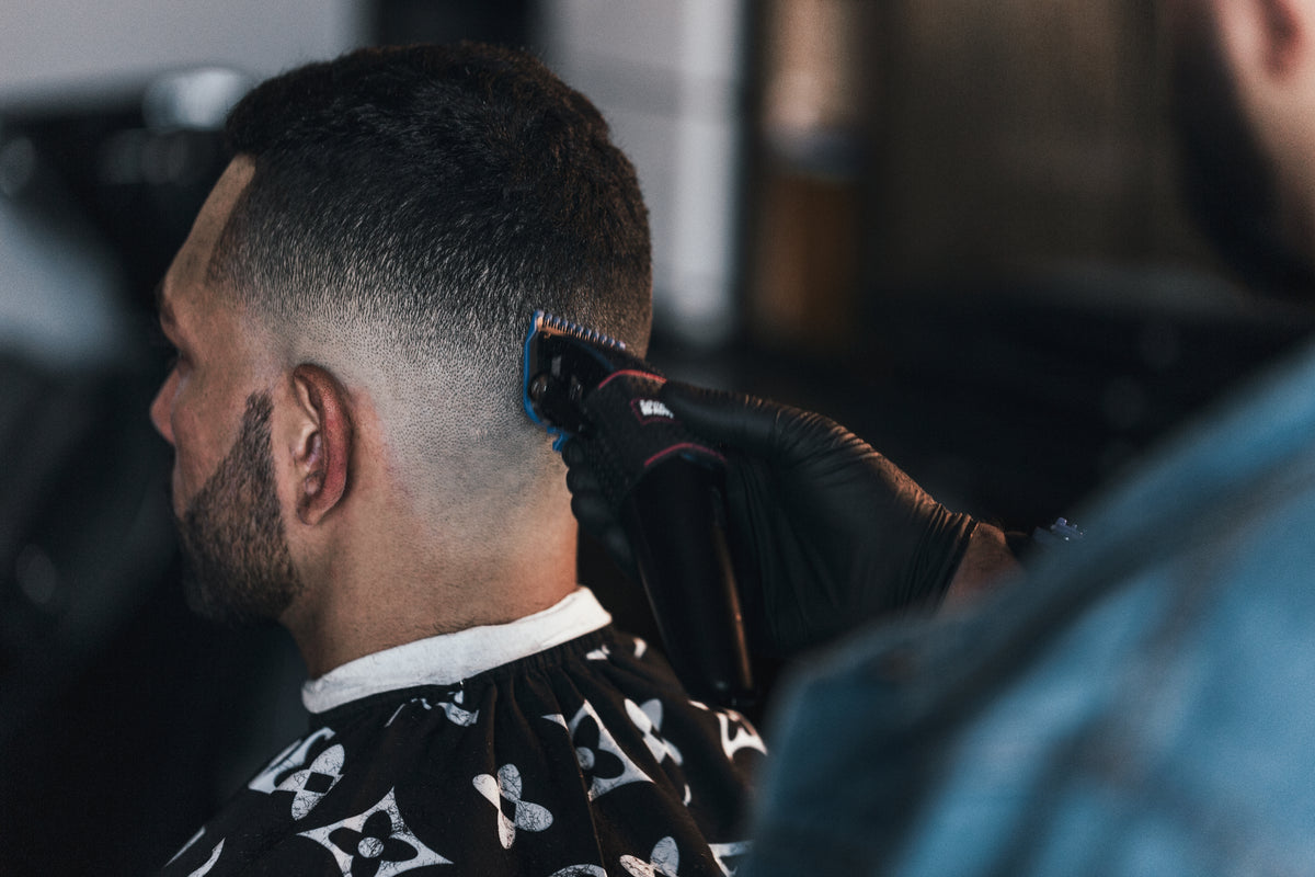 close up of barber giving a fade