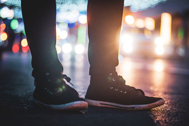 close up of black sneakers at night