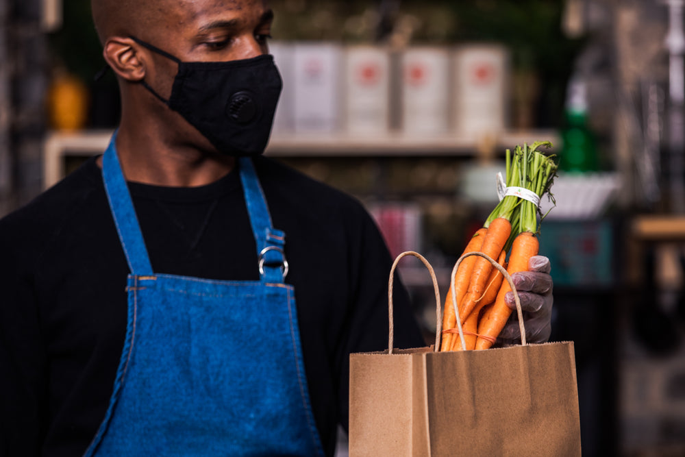 close up of carrots being put into a bag