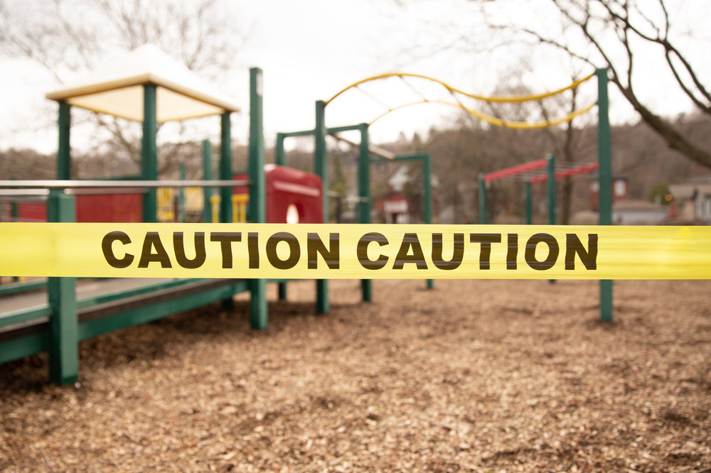 close up of caution tape surrounding a park