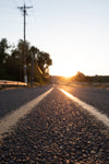 close up of country road as the sun rises