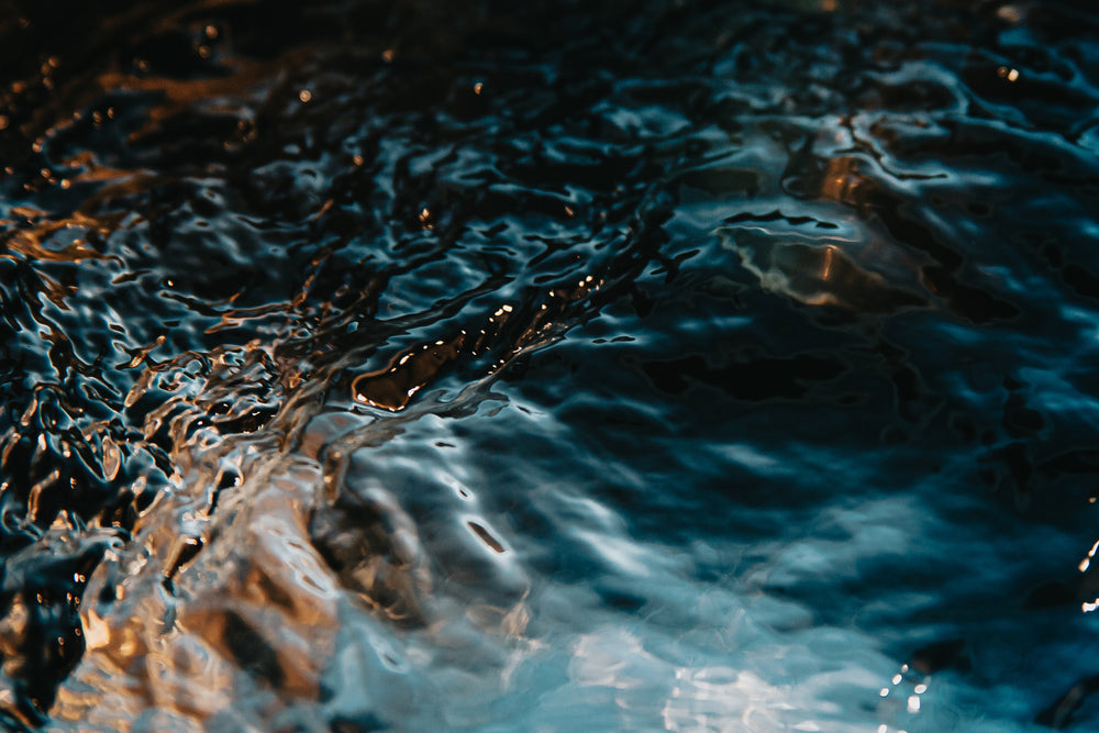 close up of flowing water glistening under the sun