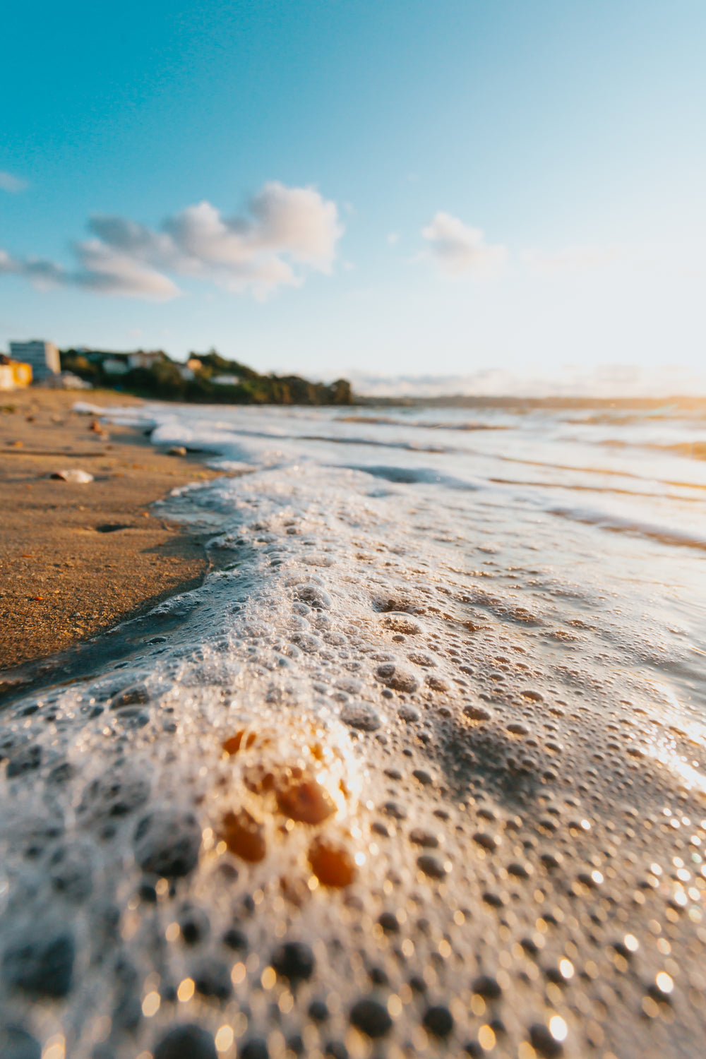 close up of lapping waves on a sandy beach