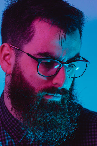 close up of mans face in pink and blue light