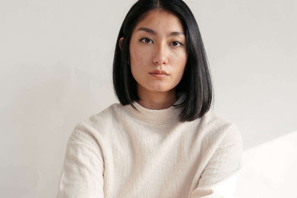 close up of model wearing cream sweater