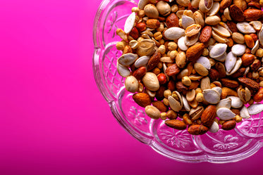 close up of nuts on pink background