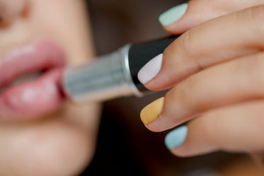 close up of person applying lipstick