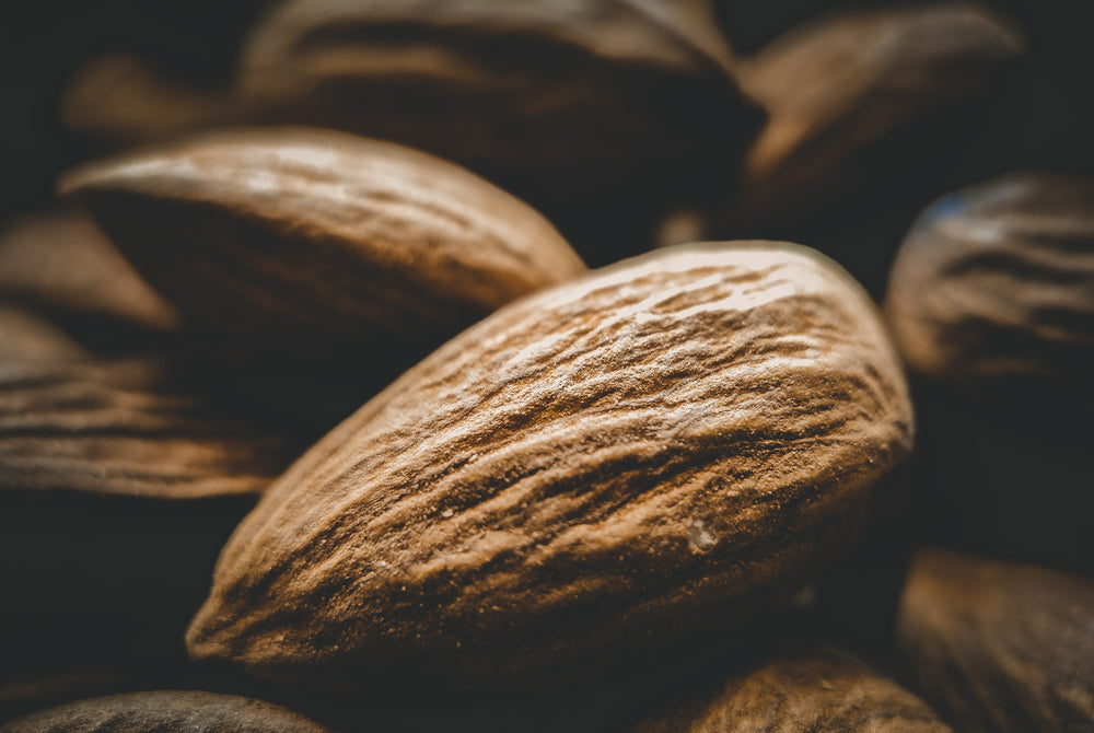 close up of scattered raw almonds