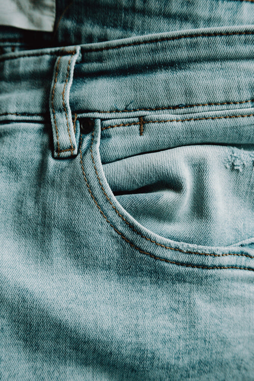 close up of the pocket of lite blue jeans