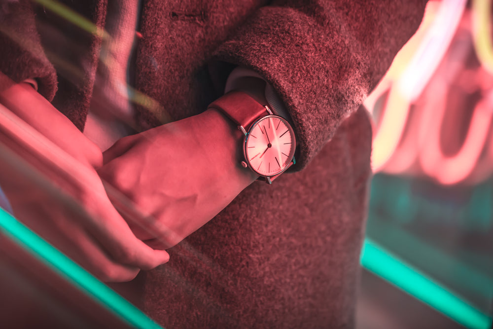 close up of watch signing under neon lights