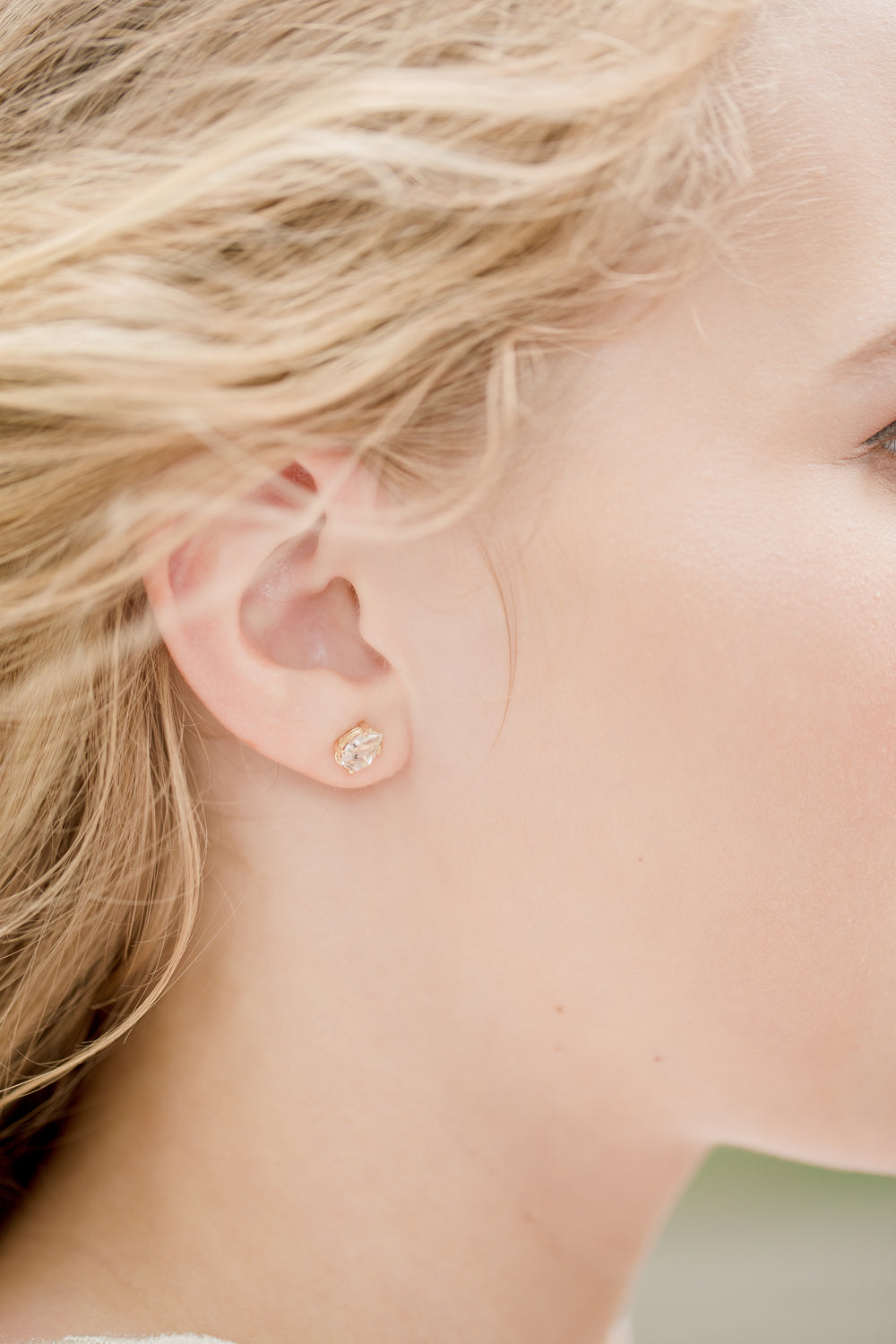 close up of women wearing diamond earring
