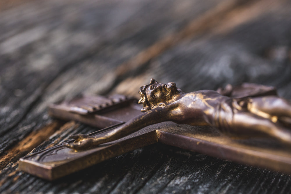 close up of wooden cross on table