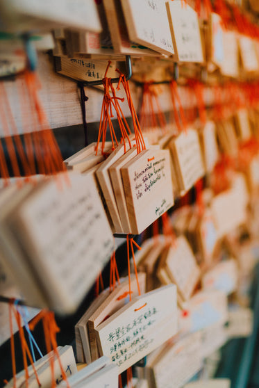 close up of wooden squares with black japanese letters