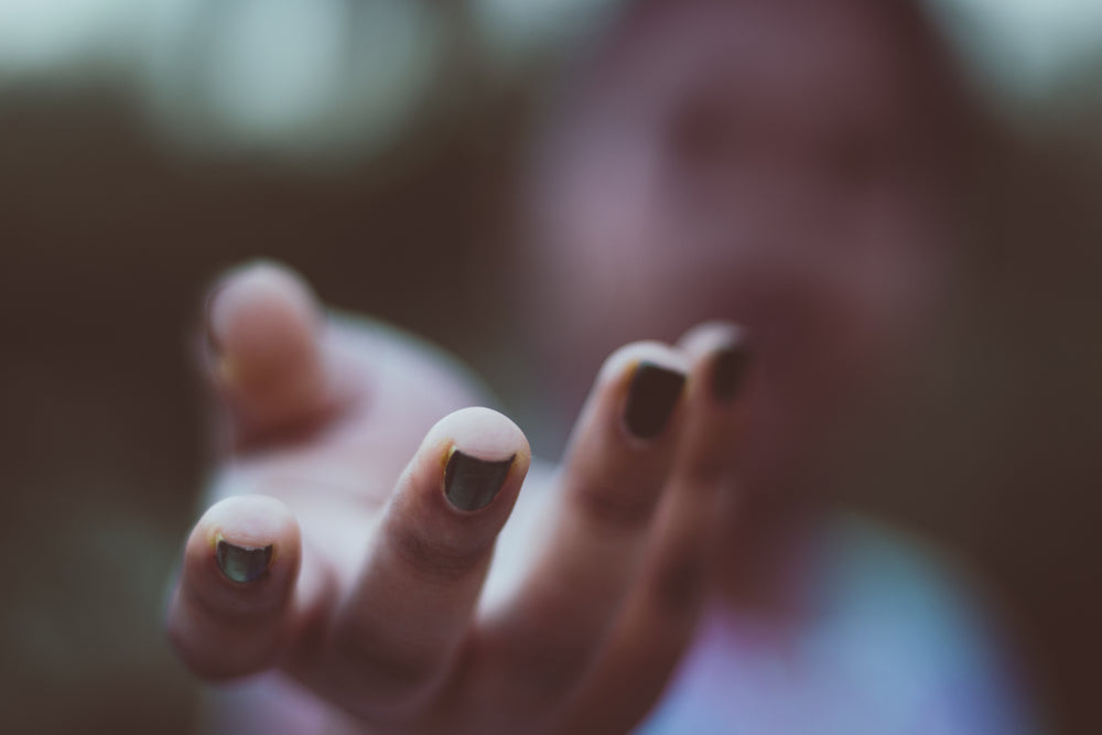 close up open hand with painted nails