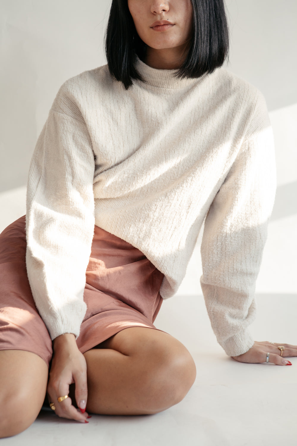 close up pink skirt and cream top