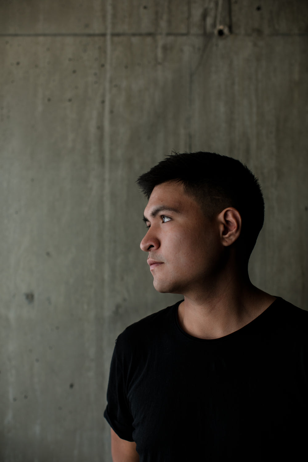 close up portrait of young adult in black tee