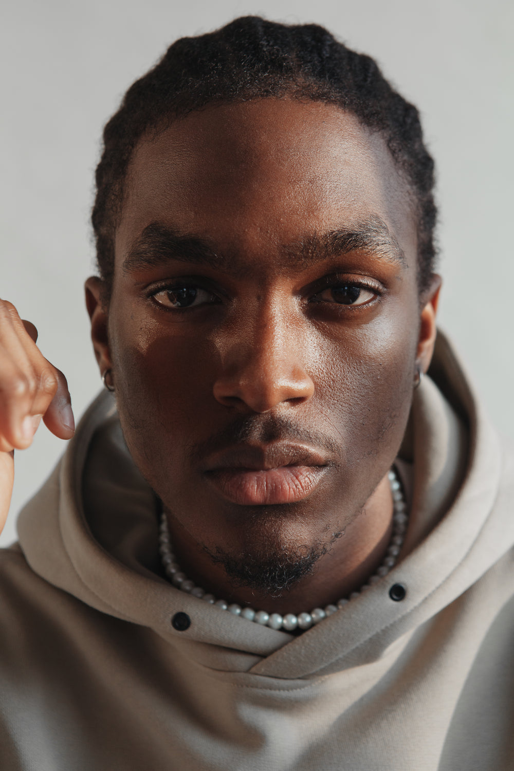 close up portrait of young man in hoodie