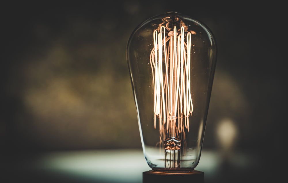 close-up view of tungsten coils glowing in an edison bulb