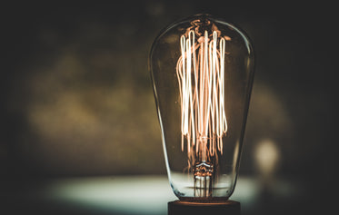 close-up view of tungsten coils glowing in an edison bulb