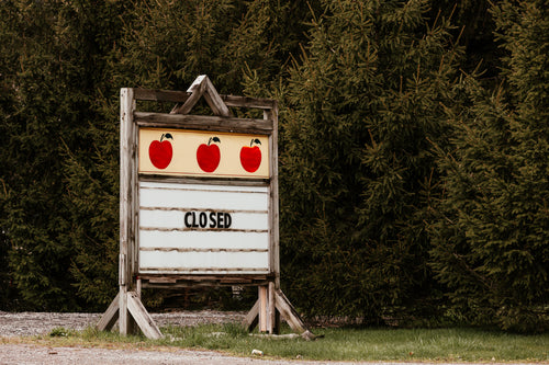 closed roadside sign by apple orchard