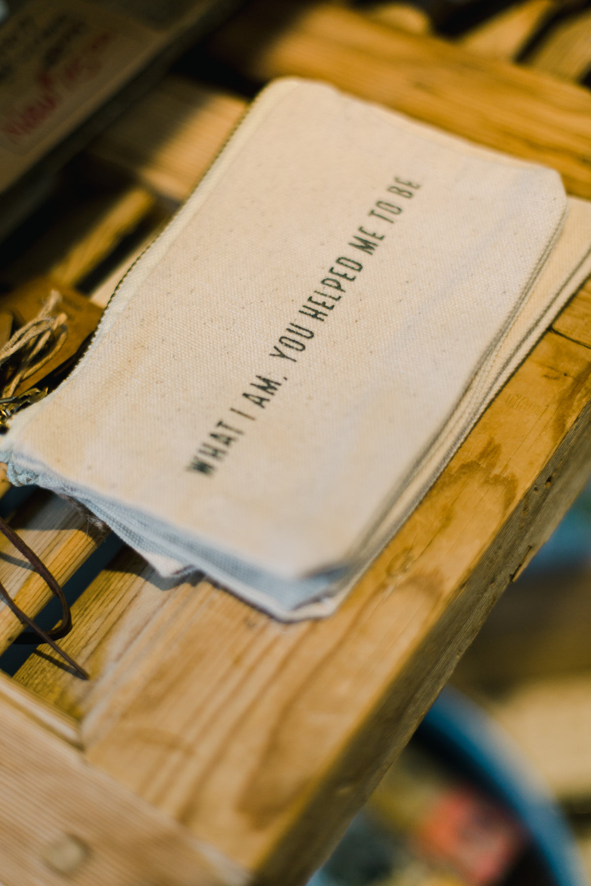 cloth bag with text on a wooden shelf