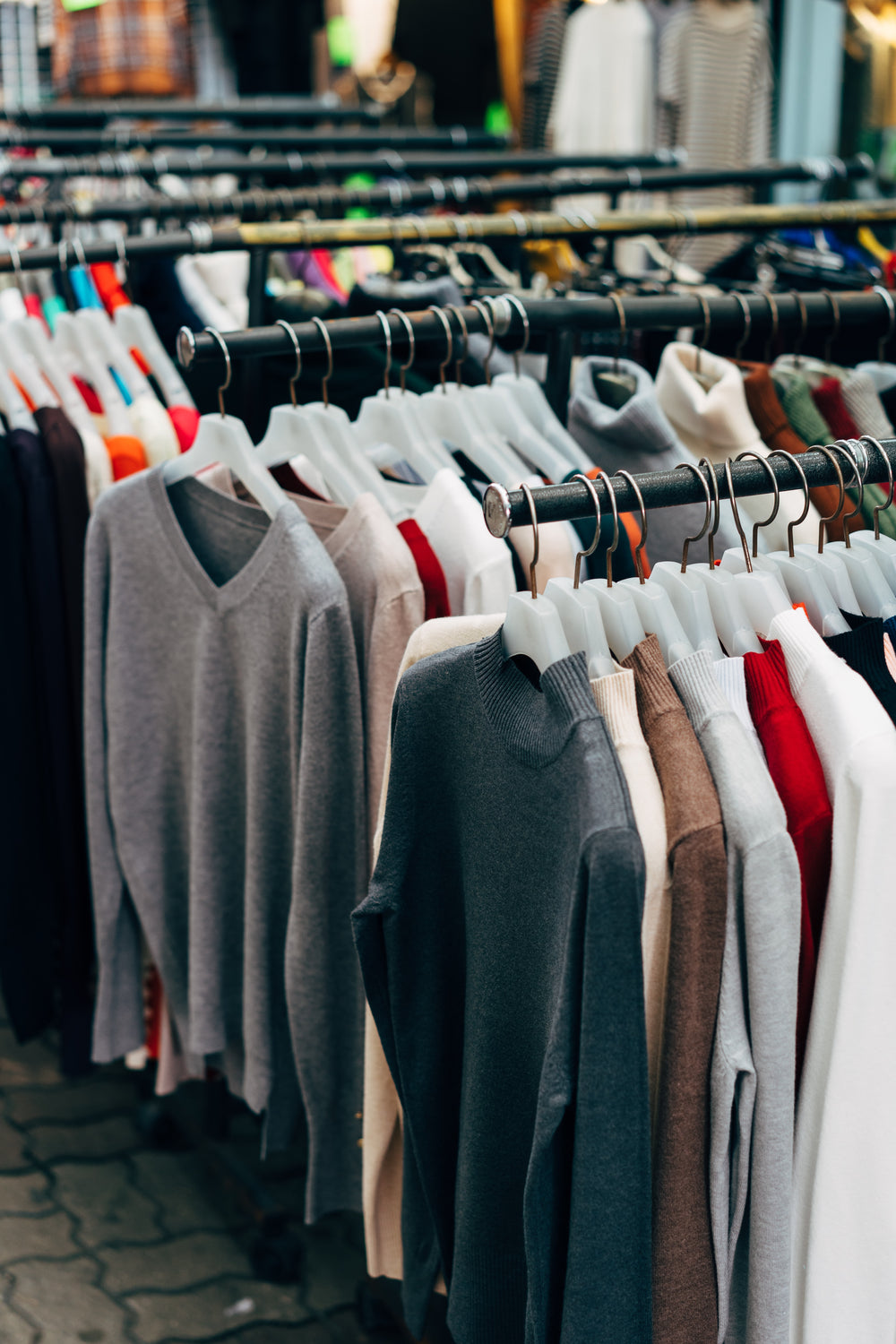 clothes on a rack in a clothing store