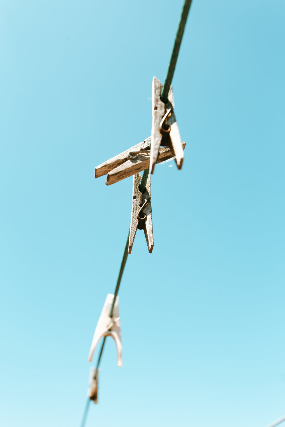 clothes pins against a bright blue sky