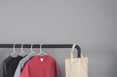 clothes rail beside gray wall