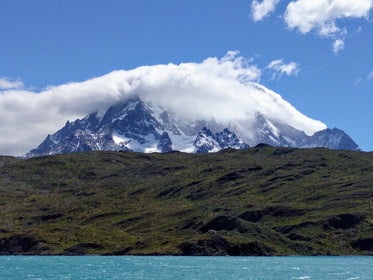 clouds around snowy mountain top