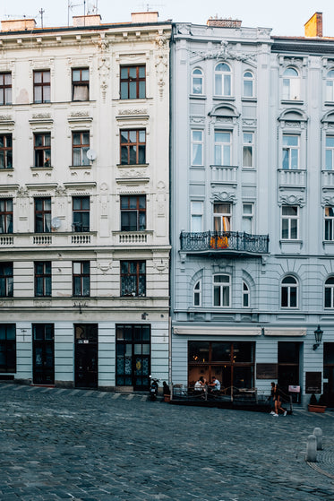 cobblestone street with tall white buildings