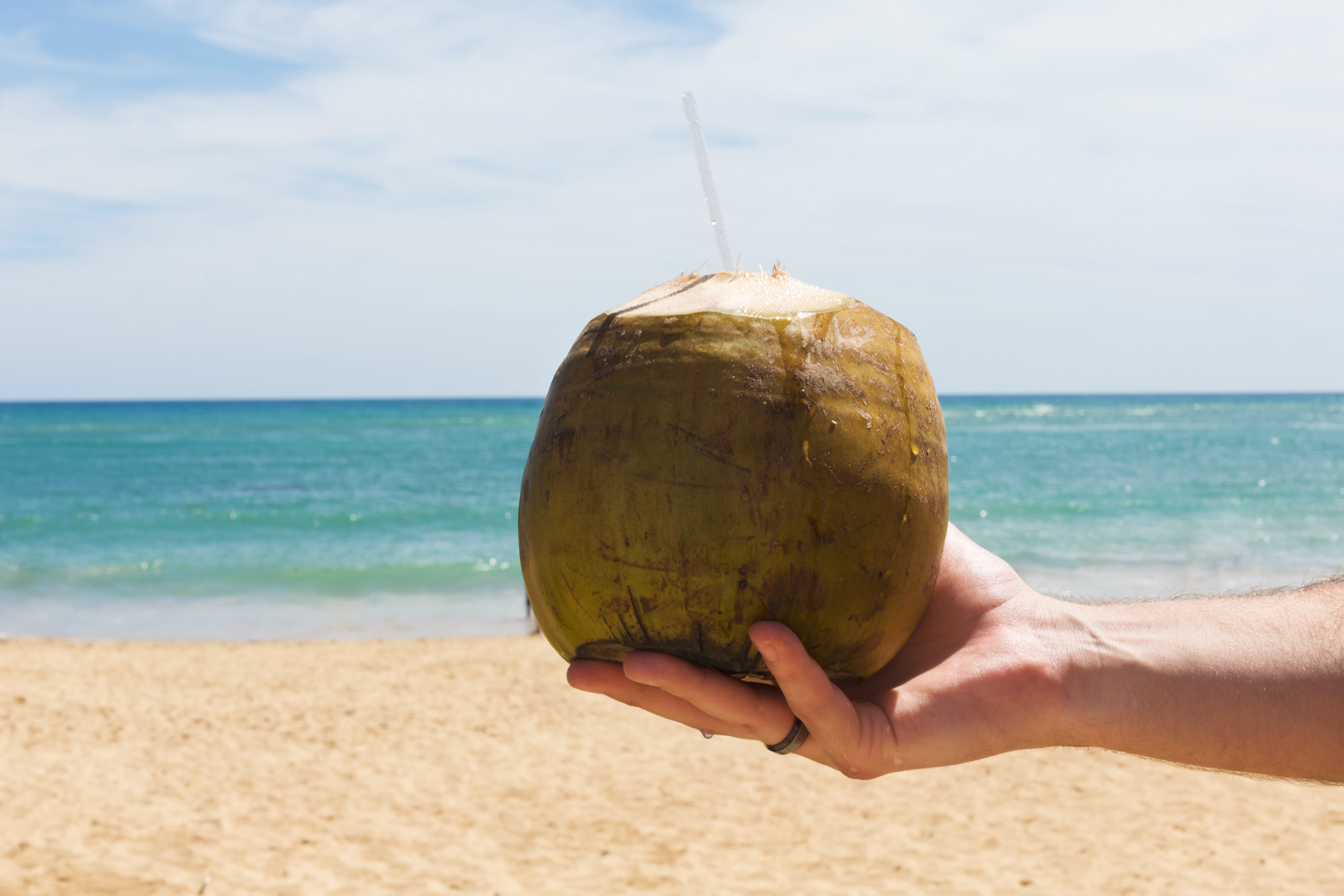 Coconut With Straw On Beach