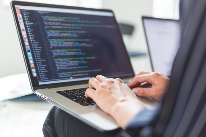 Writing theme code on a laptop