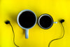 coffee and earphones on yellow background