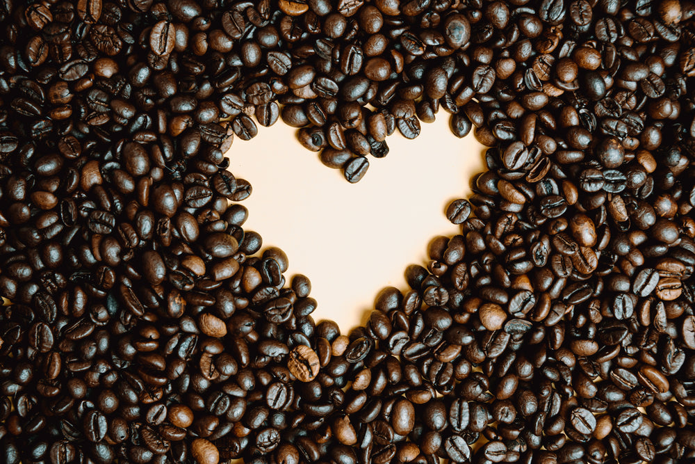 coffee beans laid on a pink background